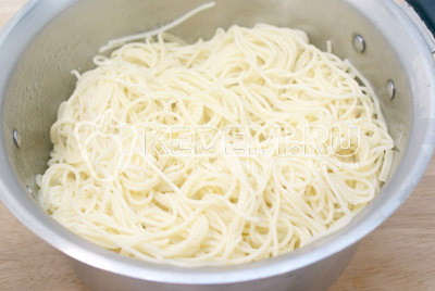 Слить воду со спагетти. Заправить спагетти сливочным маслом