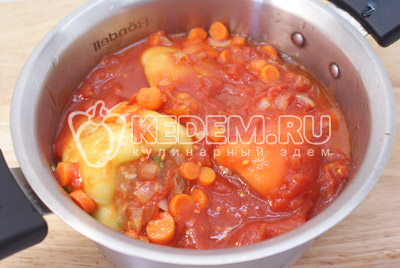 Перцы сложить в кастрюлю. Добавить овощи из сковороды и залить томатным соком. Готовить под крышкой на среднем огне 30 минут