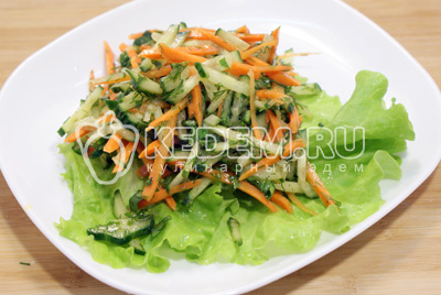Заправить овощи заправкой и добавить мелко нашивавшую зелень. Выложить на блюдо с листьями салата