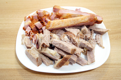 Мясо и копченые ребрышки нарезать и добавить в суп.