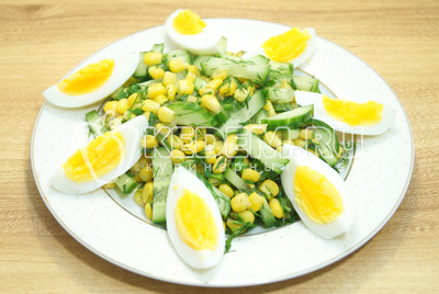 Салат выложить на блюдо и добавить ломтики яиц.