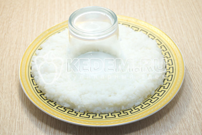Взять небольшое круглое блюдо, в середину поставить стакан. Выложить отварной рис нижним слоем на блюдо. Посолить и смазать майонезом.