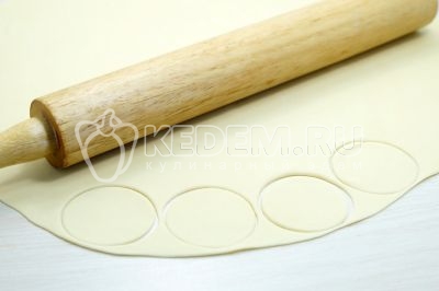 Каждую часть раскатать скалкой в тонкую лепешку и вырезать формой или стаканом кружки-сочни.