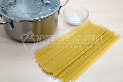 В кастрюле вскипятить 1,5 литра воды, добавить 1/2 чайной ложки соли. Добавить 300 грамм спагетти.