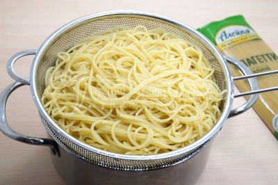 Спагетти откинуть на дуршлаг и промыть холодной водой.