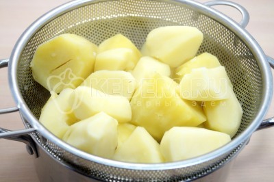 Откинуть на дуршлаг отварной картофель, чтобы слить всю воду.