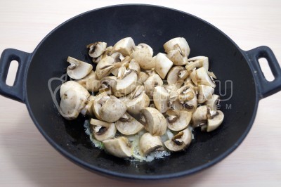 Добавить 200 грамм нарезанных грибов шампиньонов.
