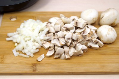 Нарезать кубиками 200 грамм свежих грибов шампиньонов и нашинковать луковицу.