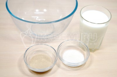 Чтобы приготовить пампушки с чесноком нужно в большой миске смешать 250 миллилитров теплого молока, 1 столовую ложку сахара и 1 чайную ложку сухих дрожжей. Оставить на 10-15 минут.