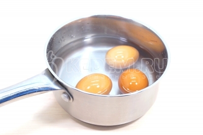 Чтобы приготовить новогодний салат с кальмарами &laquo;Сказочный берег&raquo;, нужно 3 яйца отварить, остудить и очистить.